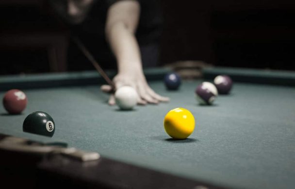 Playing pool in garage party room